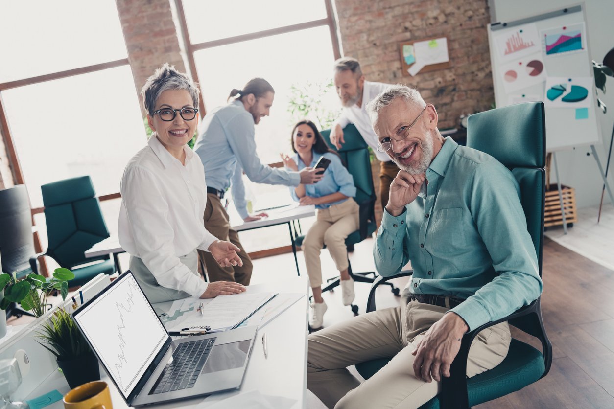 Photo of teamwork people working together communication talking comfortable modern office loft room interior indoors workspace